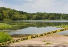 College Student Found Dead in Lake crime scene, police tape, police line, lake, investigation, shoreline, water, crime