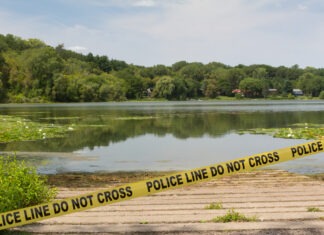 College Student Found Dead in Lake crime scene, police tape, police line, lake, investigation, shoreline, water, crime