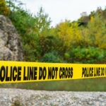 Missing Teen is Found Dead in River crime scene, police tape, police line do not cross, investigation, outdoor crime scene, law enforcement, yellow tape