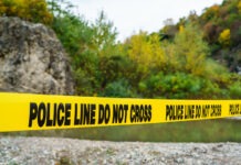 Missing Teen is Found Dead in River crime scene, police tape, police line do not cross, investigation, outdoor crime scene, law enforcement, yellow tape