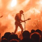 Rock Legend Discovered Dead at 77 concert, rock music, band, live performance, stage, musicians, guitarist, bass player, drummer, audience