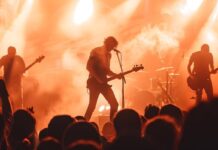 Rock Legend Discovered Dead at 77 concert, rock music, band, live performance, stage, musicians, guitarist, bass player, drummer, audience