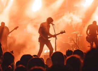 Rock Legend Discovered Dead at 77 concert, rock music, band, live performance, stage, musicians, guitarist, bass player, drummer, audience