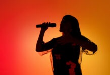Legendary Singer Rushed to the Hospital singer, performer, concert, stage performance, microphone, live music, silhouette, entertainment