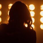 Legendary Singer Dies at 80 concert, stage lights, performance, silhouette, performer, stage, music venue, entertainment