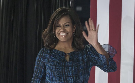 Michelle Obama, First Lady, waving, American flag, speaking event, political event