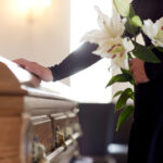 Veteran Senator Dies at 84 funeral, casket, coffin, mourner, memorial service, burial, flowers, lilies, condolences, grief