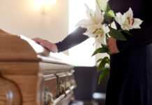 Veteran Senator Dies at 84 funeral, casket, coffin, mourner, memorial service, burial, flowers, lilies, condolences, grief