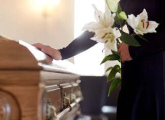 Veteran Senator Dies at 84 funeral, casket, coffin, mourner, memorial service, burial, flowers, lilies, condolences, grief