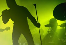 Rock Legend Collapses Mid-Concert, Rushed Off Stage concert, rock music, live performance, band, singer, guitarist, drummer, stage, music venue