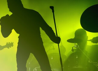 Rock Legend Collapses Mid-Concert, Rushed Off Stage concert, rock music, live performance, band, singer, guitarist, drummer, stage, music venue