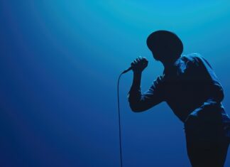 Music Icon Rushed to Hospital After Concert singer, performer, concert, stage performance, microphone, live music, entertainment, musician