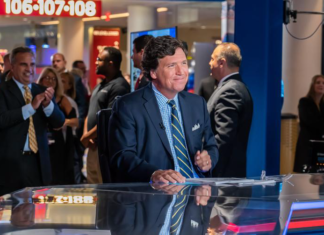 Tucker Carlson Delivers Dark Message to President news anchor, broadcast desk, television studio, newsroom, media, journalist, TV news set